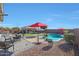 A pool with patio, gazebo, seating, gravel, and some vegetation at 22805 W Hopi St, Buckeye, AZ 85326