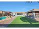 Expansive backyard boasts artificial grass, a covered gazebo, and a sparkling in-ground pool at 22805 W Hopi St, Buckeye, AZ 85326