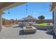 Wide backyard with fire pit, outdoor kitchen, patio, and lounge areas at 22805 W Hopi St, Buckeye, AZ 85326