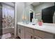 This bathroom features a floral shower curtain, toilet, and sink at 22805 W Hopi St, Buckeye, AZ 85326