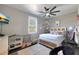 This bedroom features a ceiling fan, TV, and a bunny cage at 22805 W Hopi St, Buckeye, AZ 85326