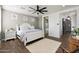 This bedroom features a ceiling fan, bathroom and shiplap walls at 22805 W Hopi St, Buckeye, AZ 85326