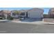 Inviting single-story home with desert landscaping, a paved driveway, and a neutral color scheme at 22805 W Hopi St, Buckeye, AZ 85326