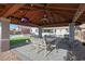 Entertainer's gazebo features an ornate dining set, television, and elegant lighting fixtures at 22805 W Hopi St, Buckeye, AZ 85326