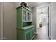 Hallway features hardwood floors and a green cabinet with glass doors at 22805 W Hopi St, Buckeye, AZ 85326