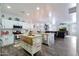 Spacious kitchen with white cabinets, granite counters, and views into the living room at 22805 W Hopi St, Buckeye, AZ 85326