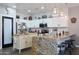 Charming kitchen featuring white cabinets, granite counters, and stainless steel appliances at 22805 W Hopi St, Buckeye, AZ 85326
