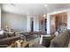 Comfortable living room featuring hardwood floors, neutral walls, a large sofa, and a view of a hallway and dining area at 22805 W Hopi St, Buckeye, AZ 85326