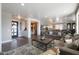 Spacious, open-concept living room with hardwood floors, a modern rug, comfortable seating, and views into the dining and kitchen areas at 22805 W Hopi St, Buckeye, AZ 85326