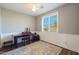 This office features a large window, ceiling fan, and desk at 22805 W Hopi St, Buckeye, AZ 85326