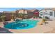 Beautiful backyard pool with rock features and lush tropical landscaping for a serene outdoor oasis at 22805 W Hopi St, Buckeye, AZ 85326