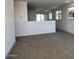 Open-concept living room with tile flooring and abundant natural light at 23252 W Miami St, Buckeye, AZ 85326