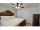 Primary bedroom with a decorative wood frame bed, neutral walls, ceiling fan and hardwood floors at 2926 W Echo Ln, Phoenix, AZ 85051