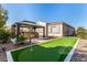Backyard featuring an outdoor kitchen with a gazebo, putting green, and lush landscaping at 3005 E Valencia Dr, Phoenix, AZ 85042