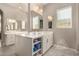 Bathroom featuring dual vanities with ample counter space, large mirrors, and soft, natural light at 3005 E Valencia Dr, Phoenix, AZ 85042
