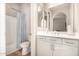 Well-lit bathroom features a shower and a single sink vanity with storage at 3005 E Valencia Dr, Phoenix, AZ 85042