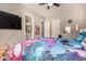 Bright bedroom features a ceiling fan, wood-look floors and an ensuite bathroom at 3005 E Valencia Dr, Phoenix, AZ 85042