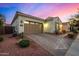 Single-story home with a two-car garage, desert landscaping, and tile roof at 3005 E Valencia Dr, Phoenix, AZ 85042