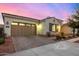 Charming home exterior with a brick driveway, a two-car garage, and manicured landscaping at 3005 E Valencia Dr, Phoenix, AZ 85042