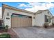 Close up of a one-story home with desert landscaping, a paver driveway and a two-car garage at 3005 E Valencia Dr, Phoenix, AZ 85042