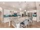 Bright kitchen with a large island, bar seating, granite counters, and glass-front cabinets at 3005 E Valencia Dr, Phoenix, AZ 85042