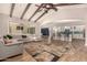 Spacious living room open to the kitchen with vaulted ceilings and a large sectional sofa at 3005 E Valencia Dr, Phoenix, AZ 85042