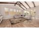 Bright living room with wood-beamed ceilings, a large sectional, and ample natural light at 3005 E Valencia Dr, Phoenix, AZ 85042