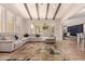Spacious living room with wood-beamed ceilings, a large sectional, and sliding glass doors at 3005 E Valencia Dr, Phoenix, AZ 85042