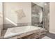 Relaxing bathroom with a soaking tub and separate glass-enclosed shower at 3005 E Valencia Dr, Phoenix, AZ 85042