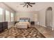 Bedroom featuring neutral walls, wood floors, ceiling fan, and natural light from two windows at 3005 E Valencia Dr, Phoenix, AZ 85042