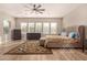 Well-lit main bedroom with a tufted headboard, three large windows, and neutral tones at 3005 E Valencia Dr, Phoenix, AZ 85042