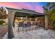 Outdoor bar area featuring stone accents, seating for four, and a covered gazebo at 3005 E Valencia Dr, Phoenix, AZ 85042