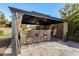 Backyard outdoor kitchen with bar seating, stone accents, and covered gazebo, great for entertaining guests at 3005 E Valencia Dr, Phoenix, AZ 85042