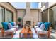 Inviting outdoor patio features a fireplace and comfortable seating for entertaining at 3005 E Valencia Dr, Phoenix, AZ 85042