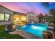 Backyard pool featuring pavers, lounge chairs, and a covered patio connected to the main house at 3005 E Valencia Dr, Phoenix, AZ 85042