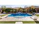 Backyard pool with a spa, waterfall feature, and lush landscaping, creating a serene outdoor oasis at 3005 E Valencia Dr, Phoenix, AZ 85042