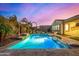 Inviting backyard pool with a pergola, lush landscaping, and an expansive patio, perfect for outdoor relaxation at 3005 E Valencia Dr, Phoenix, AZ 85042