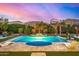 Beautiful backyard pool with elegant landscaping and a serene atmosphere under a colorful evening sky at 3005 E Valencia Dr, Phoenix, AZ 85042