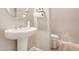 Cozy powder room with pedestal sink and convenient toilet location at 3005 E Valencia Dr, Phoenix, AZ 85042