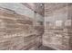 Modern tiled walk-in shower boasts elegant fixtures and a spa-like feel at 3005 E Valencia Dr, Phoenix, AZ 85042