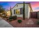 Stylish home exterior with desert landscaping, manicured shrubs, and dark brown shutters at 3005 E Valencia Dr, Phoenix, AZ 85042
