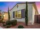 Stylish home exterior with desert landscaping, manicured shrubs, and dark brown shutters at 3005 E Valencia Dr, Phoenix, AZ 85042