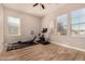 Bright workout room featuring wood-look floors, two large windows and exercise equipment at 3005 E Valencia Dr, Phoenix, AZ 85042