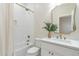 Well-appointed bathroom with a combination tub and shower, marble vanity, and decorative accents at 3063 E Warbler Rd, Gilbert, AZ 85297