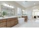 Bright bathroom features soaking tub, double vanity, patterned tile floor and shower at 3063 E Warbler Rd, Gilbert, AZ 85297