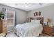 Cozy bedroom with queen size bed, ceiling fan, window with blinds, and two side tables with lamps at 30857 N Karen Ave, San Tan Valley, AZ 85143