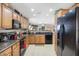 Well-equipped kitchen featuring granite countertops, stainless steel appliances, and wood cabinetry at 30857 N Karen Ave, San Tan Valley, AZ 85143