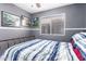 Bedroom featuring gray walls, ceiling fan, natural light, and a comfortable bed at 3403 E Kristal Way, Phoenix, AZ 85050