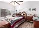 Cozy bedroom with vaulted ceiling, ceiling fan, wood-look floors, and a comfortable bed at 3403 E Kristal Way, Phoenix, AZ 85050