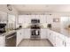 Kitchen featuring stainless appliances, granite counters, white cabinets, and modern lighting at 3403 E Kristal Way, Phoenix, AZ 85050